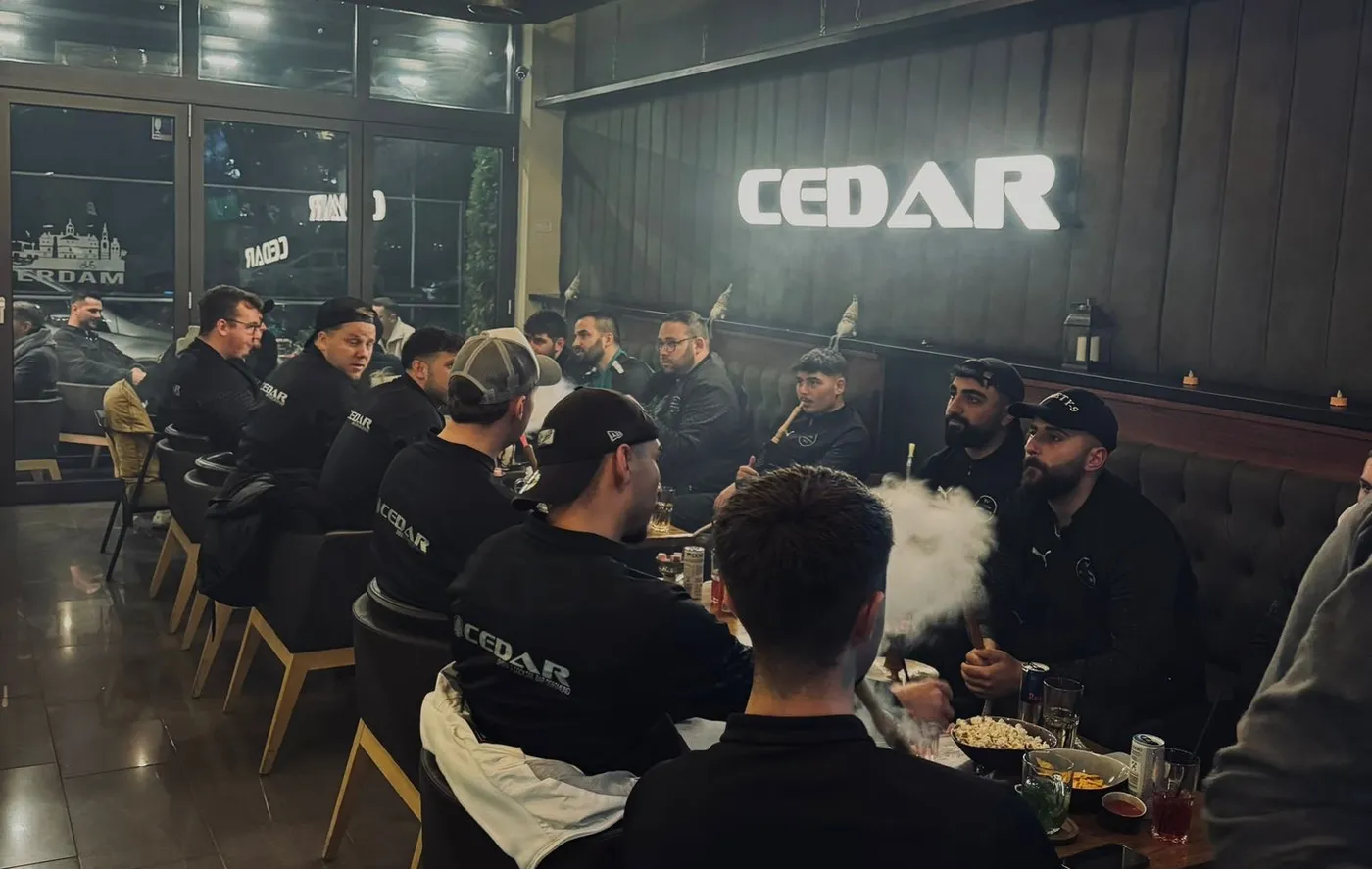 Inside Cedar Lounge Dortmund under the lit CEDAR sign